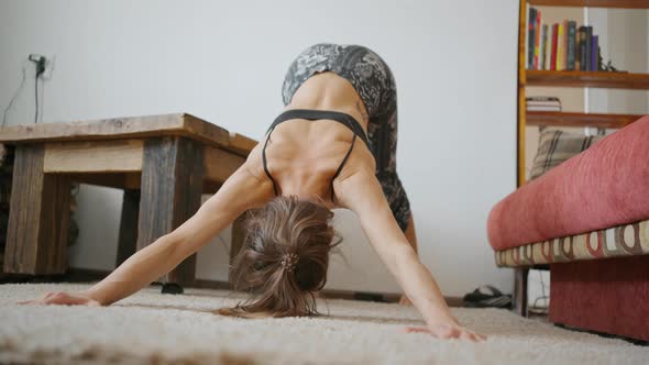 Woman Does Yoga and Stretching Exercises at Home alt