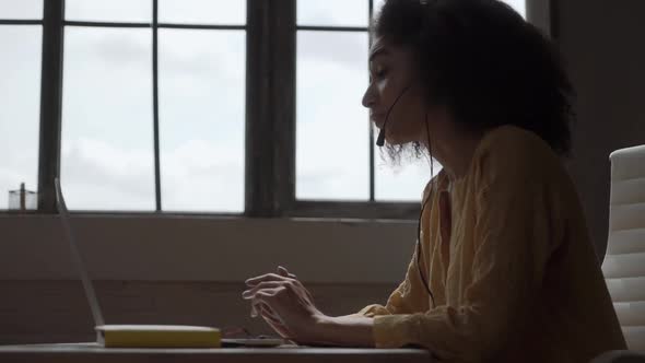 Smiling African American Woman with Headset Using Laptop, Talking, Working Customer Support Service alt