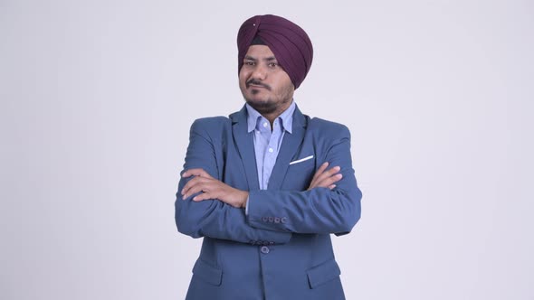 Angry Bearded Indian Sikh Businessman with Arms Crossed alt