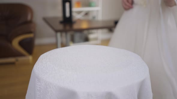 Closeup Table with Unrecognizable Bride in Wedding Dress Passing in Slow Motion Leaving Bridal alt