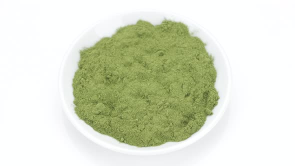 Super food. green powder superfood chlorella or spirulina isolated on white background alt