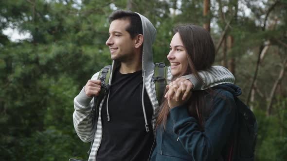 Lovely Couple on the Walk in Forest, Smiling and Looking Into the Distance alt
