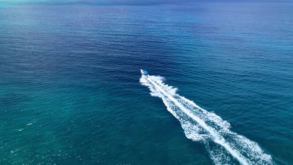 Aerial Drone Shot Over Speed Boat with small waves in Ocean.
