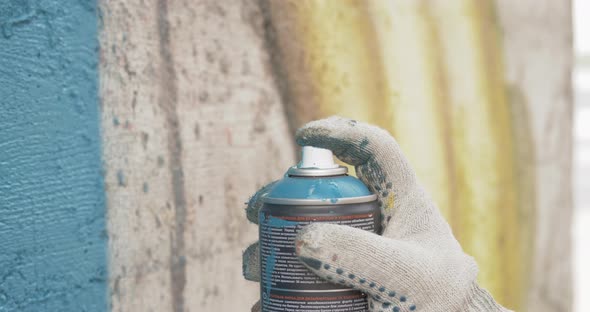 Graffiti Artist Hands with Paint Cans