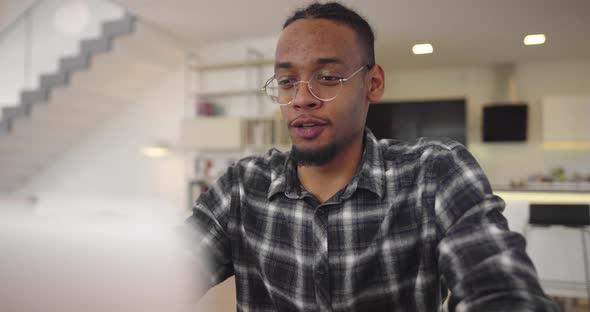 African American Businessman Making Online Conference Video Call Using Smartphone and Laptop alt