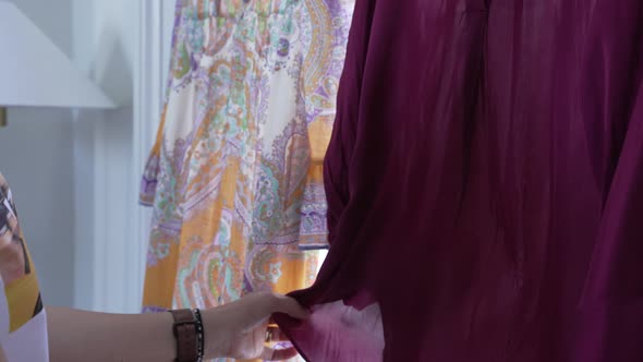 Woman uses steam cleaner to freshen up a hanging garment. 4 x slow motion. alt