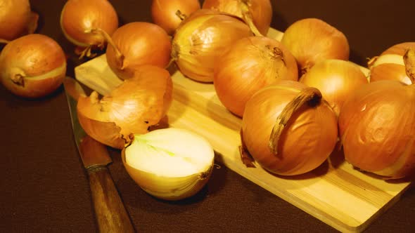 Large Yellow Ripe Bulbs Lie on a Wooden Board on the Table