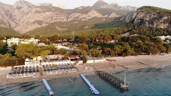 Aerial View of the Rows of Sun Loungers on the Sea Beach and a Large Hotel with Many Pools on the alt