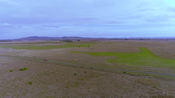 Aerial view of the road in the fields near where the car passes