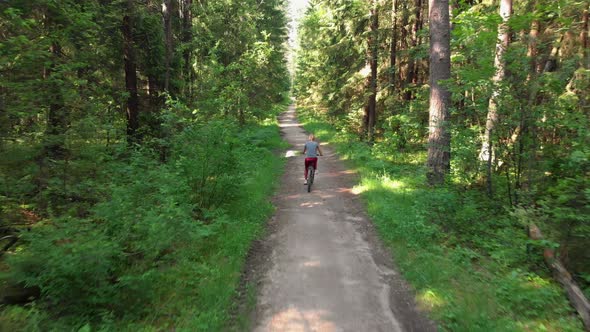 Young Cyclist Riding on a Nice Road alt
