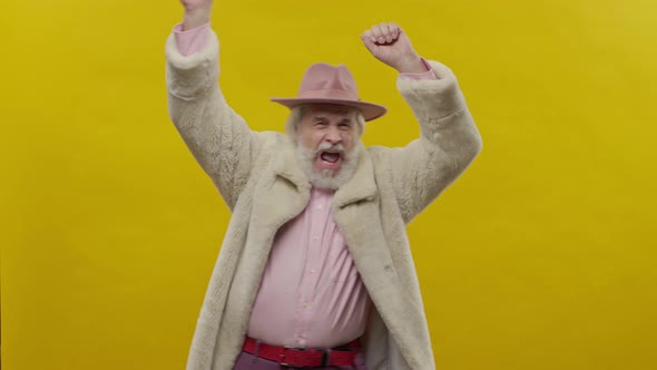 Stylish Old Man In Pink Clothes On Yellow Background alt