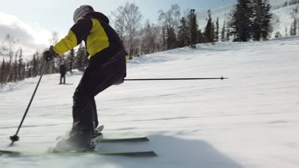 Skiing alone on perfectly groomed ski piste at ski resort alt