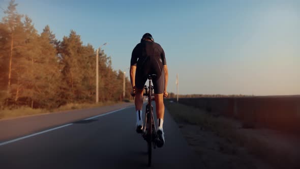 Cycling Men Pedaling Workout Road Bicycle. Fit Cyclist Riding On Road Bike Triathlete Fitness. alt