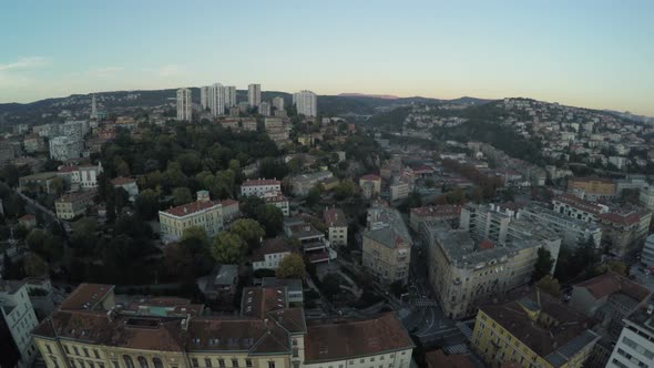 Aerial view of buildings on hills alt