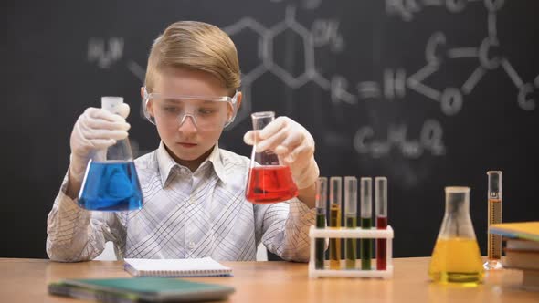 Little Nerd Comparing Liquids in Flasks and Writing Reaction Results, Innovation alt