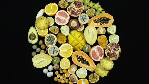 Rotating Exotic And Tropical Fruits On Black Background Top View.