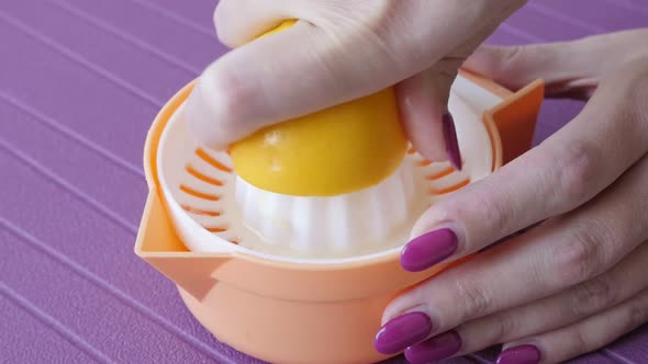 Slow motion on manual citrus juicer used for healthy drink close-up 1920X1080 HD footage - Lemonade  alt