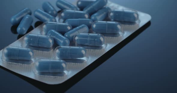 Prescription drugs - Capsules, pills, tablets on reflective background alt