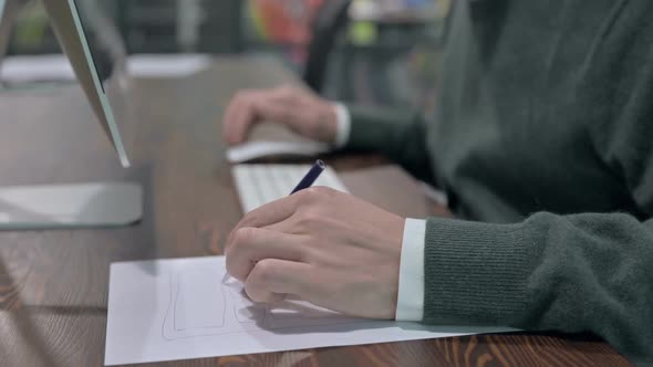 Close Up Shoot of Man Hand Using Keyboard and Making Notes alt