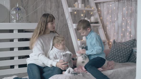 Blond Mother Son and Daughter Play with Stuffed Soft Toys alt