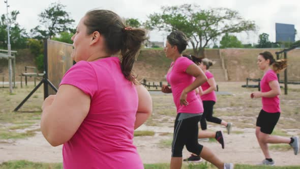 Female friends enjoying exercising at boot camp together alt