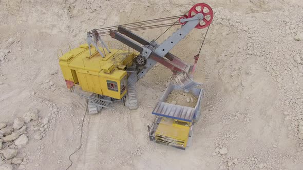 High angle of an excavator loading ballast alt