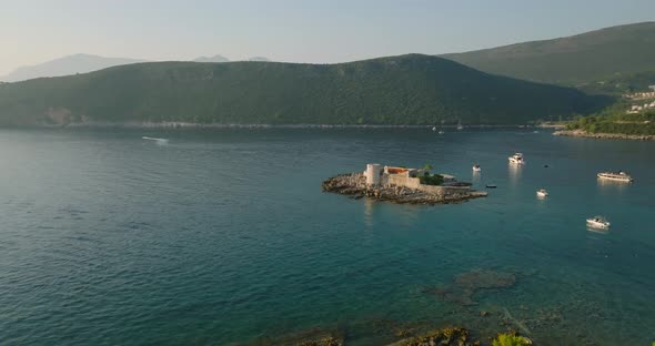moving away from Otocic Gospa island with boats and yachts on background alt