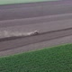 Agricultural Tractor Plowing The Fields With Ripe Wheat Crops In The Distance - VideoHive Item for Sale