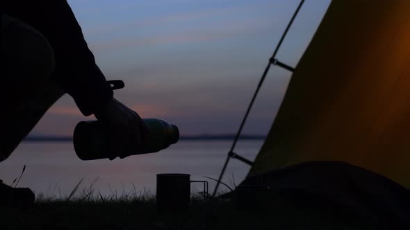 The Traveler is Pouring a Hot Drink alt