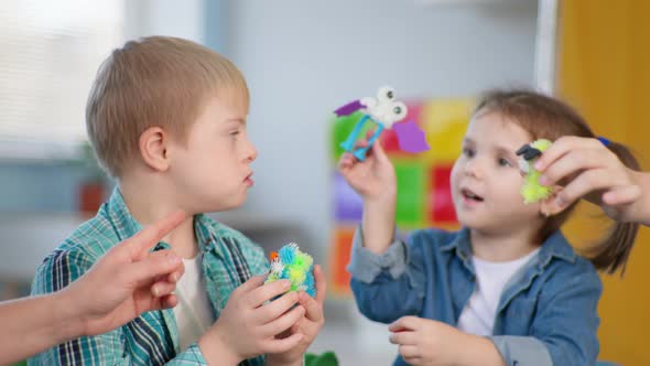 Children with Down Syndrome Have Fun in an Educational Therapy Lesson for Children with Disabilities alt