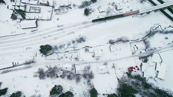 Aerial Overhead View of the Train Travels Through the Countryside in Winter