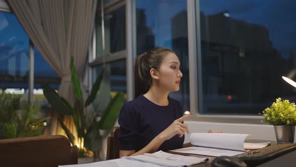 Asian  home working late at night. alt