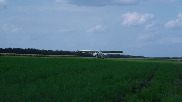 Lightweight Airplane Landing Airfield with Spinning Propeller Turning Off Engine alt