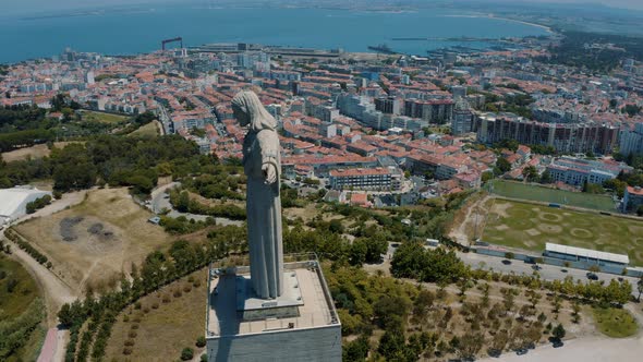 Panoramic orbit view over the Statue Santuario De Cristo Rei, Lisbon Portugal 4K