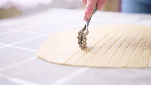 Apple Pie Cake Preparation Series  Woman Slicing Rolled Dough with Rolling Knife alt