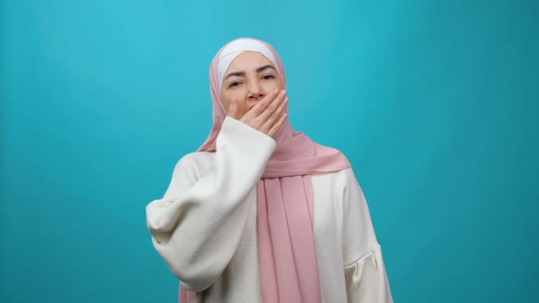 Exhausted Young Muslim Woman in Hijab Yawning Widely Looking Sleepy and Drowsy Stretching Hands Up