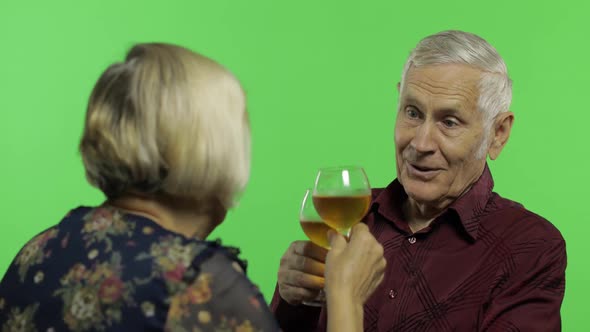 Senior Aged Man Drinking Wine with a Elderly Woman Companion on Chroma Key alt