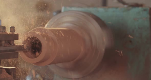 Man working on a wood lathe creating art - slow motion macro shot alt