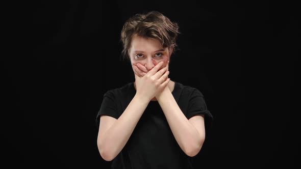 Helpless Oppressed Young Woman with Bruises on Face and Mouth Closed with Hands Looking at Camera alt
