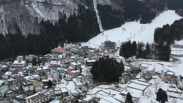 aerial of chair ski lift in nozawa onsen village during early winter in nagano japan alt