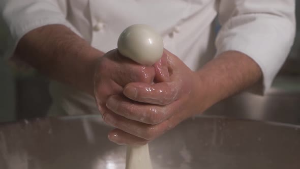 The Chef at the Enterprise Produces Milk White Cheese Mozzarella By Hand