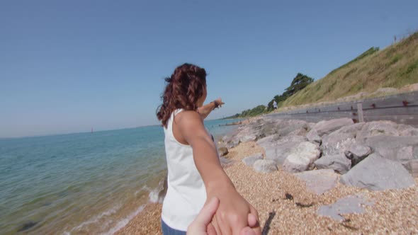 POV Shot of Girl Pulling Boyfriend Along The Beach His Hand in Slowmotion alt