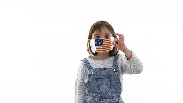 On the child a protective medical mask with flag of USA 