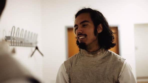 Fencer Taking Masks From Hooks alt