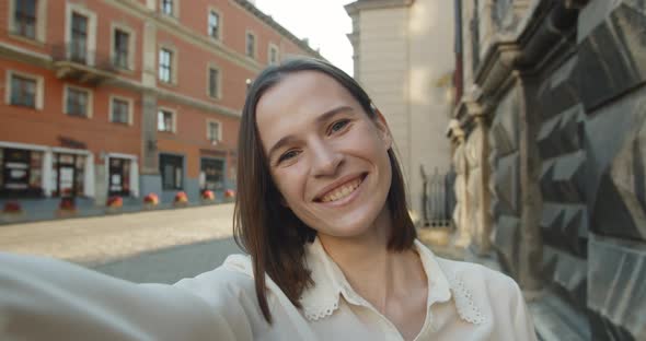 Young Attractive Woman Having Video Conversation and Smiling. Happy Female Using Smartphone for alt
