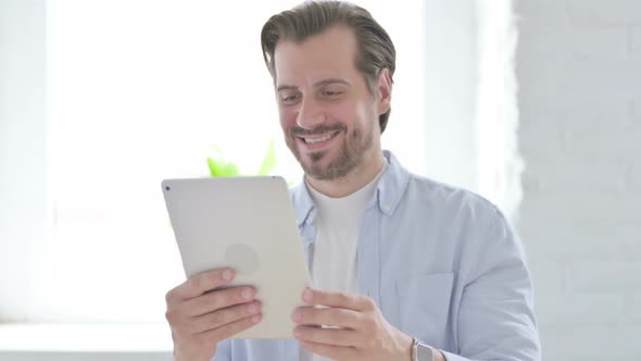 Video Call on Tablet By Talking Young Man alt