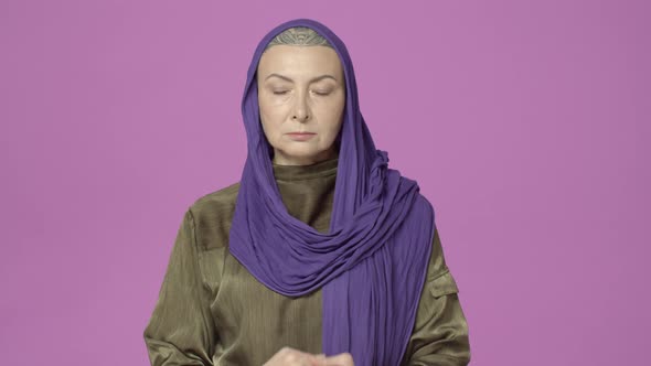 Patient Calm and Openminded Middleaged Woman Bald Tattoed Head Covered in Hood Meditating Practice alt