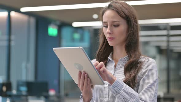 Portrait of Young Businesswoman Reacting to Loss on Tablet alt