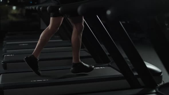 Athletic Runner Man Run on a Treadmill Aerobic Exercise and Endurance Training in the Gym Night alt