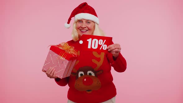 Grandmother in Christmas Sweater Showing Gift Box and 10 Percent Discount Inscriptions Banner Text alt
